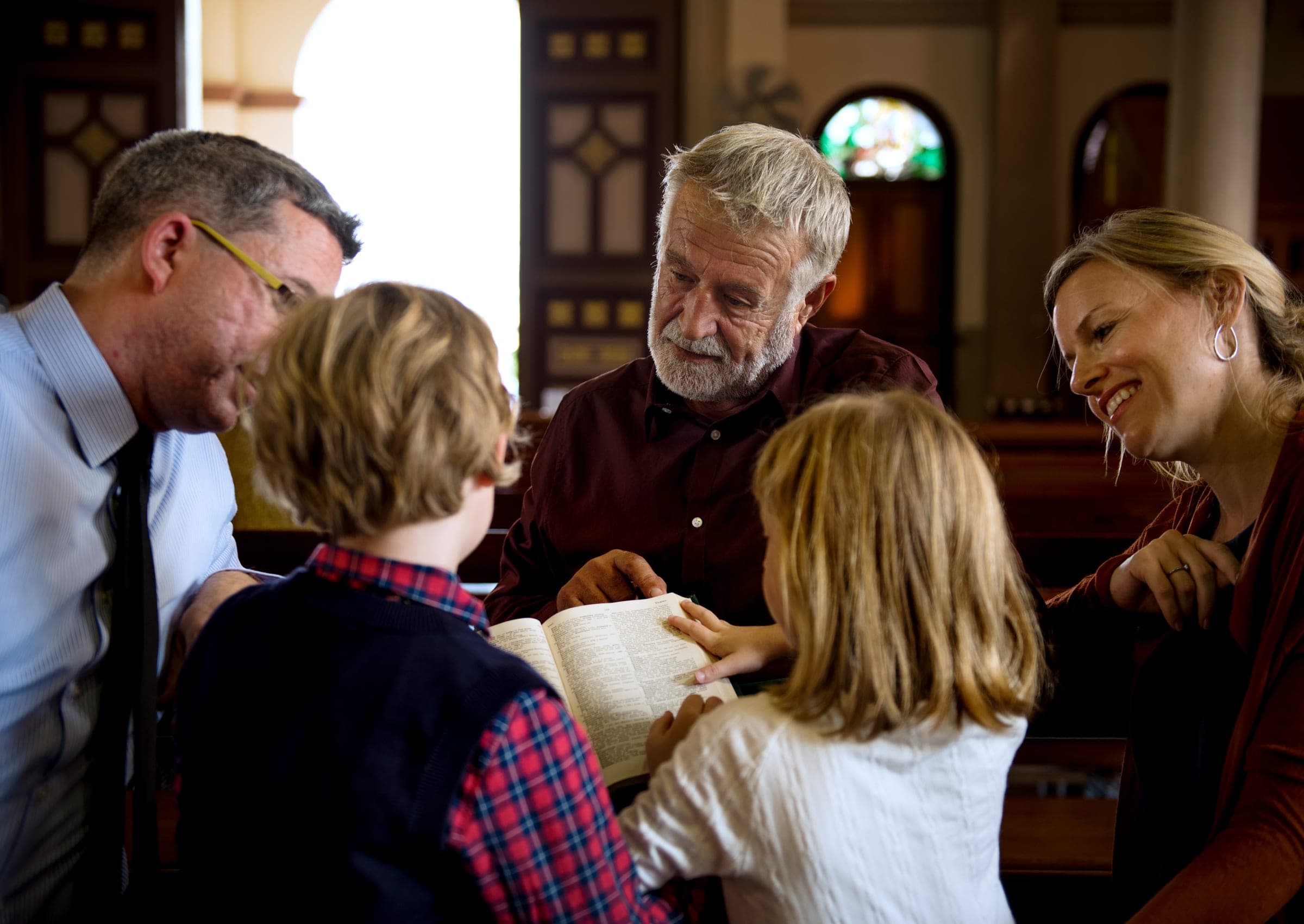 Believers gathered in worship with hands raised