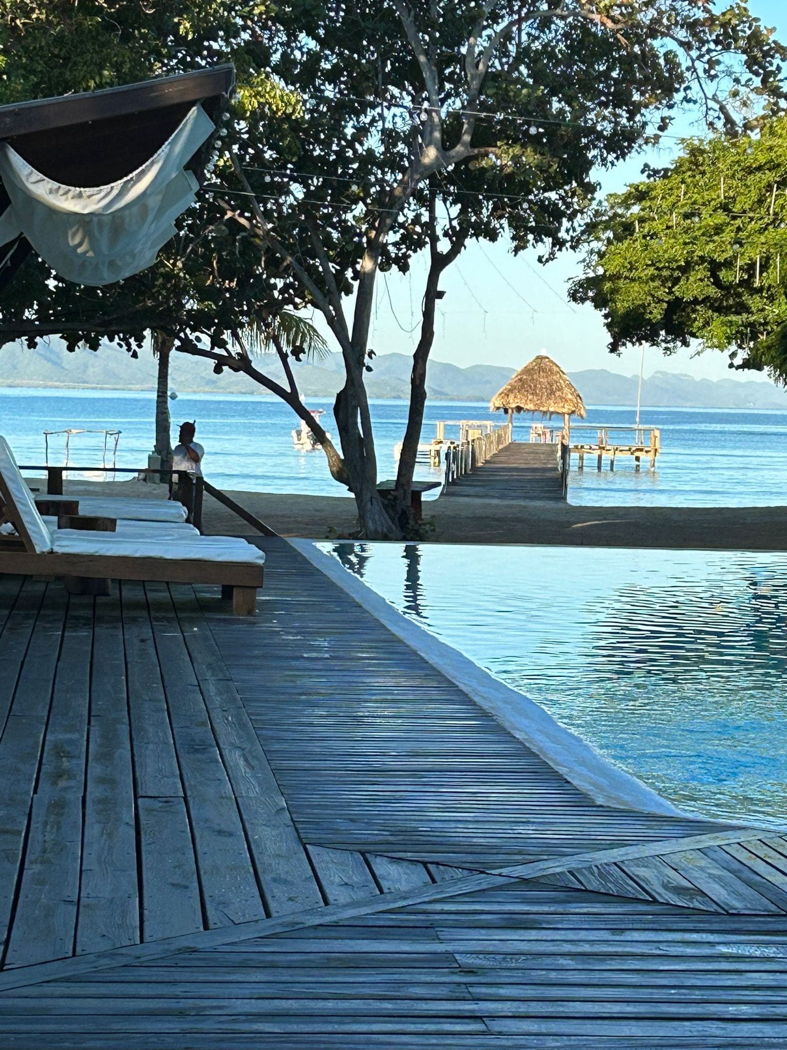 The dock and thatched palapa at Maranatha Cove, seen from the pool deck