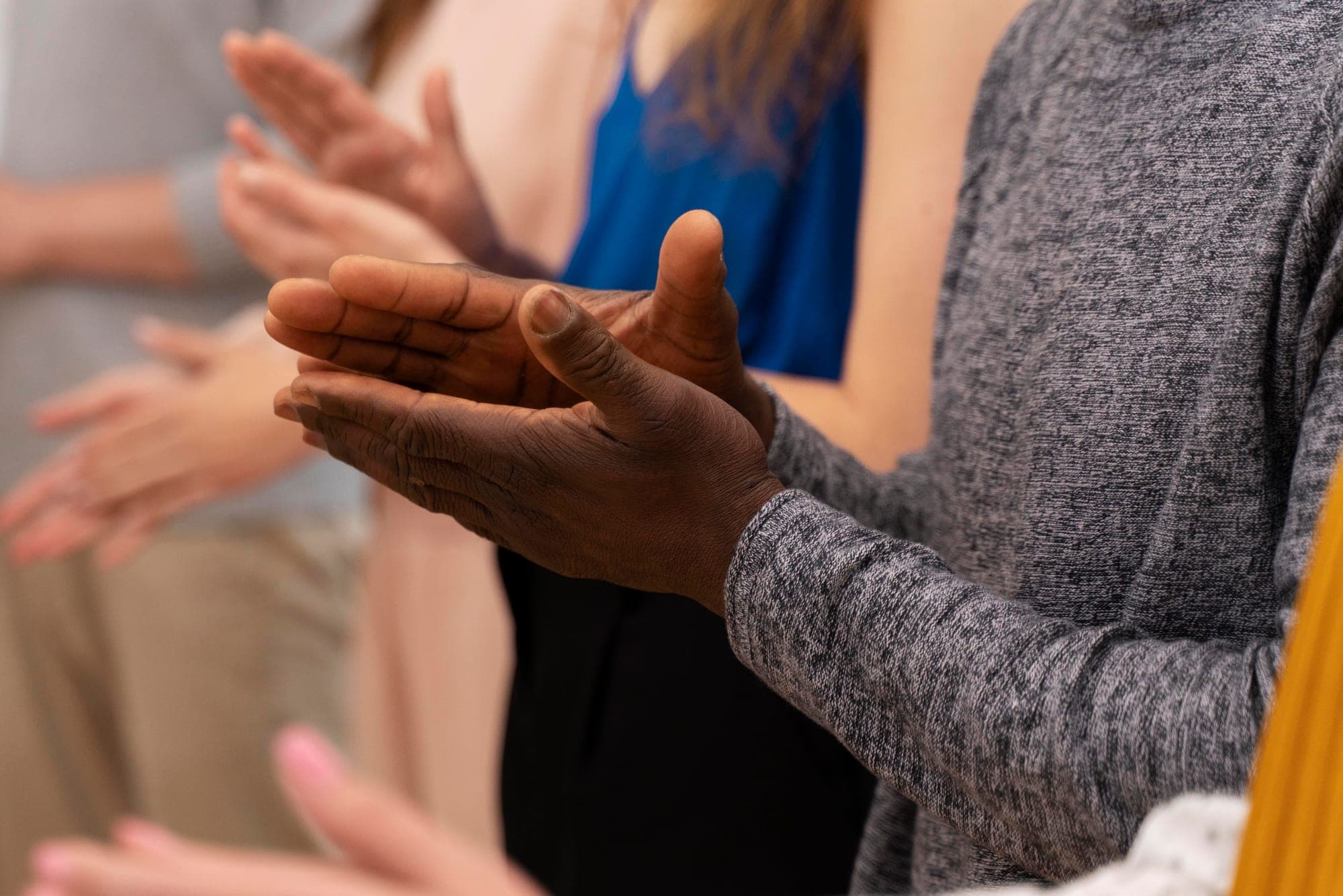Hands applauding together at a ministry gathering